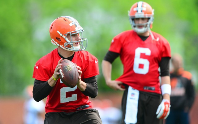 Brian Hoyer looks over the shoulder of his backup, Johnny Manziel. (USATSI)