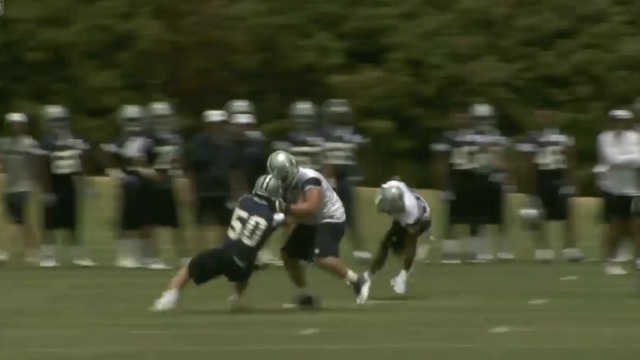Sean Lee gets pancaked here by Zack Martin on Tuesday. (NFL.com)