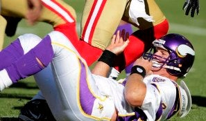 B. Favre reacts after taking a sack from P. Willis on Sunday (AP).