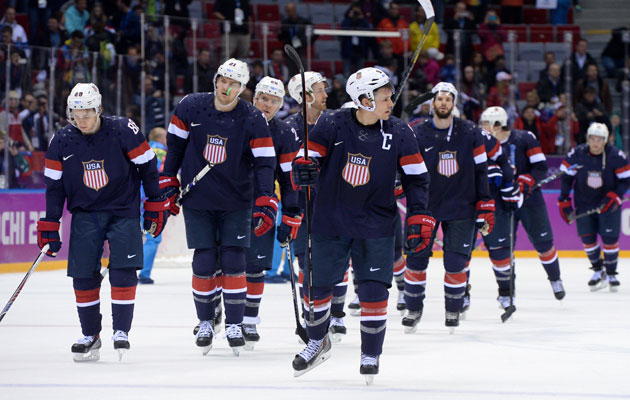 Team USA leaves the ice looking dejected after the loss to Finland. (Getty Images)