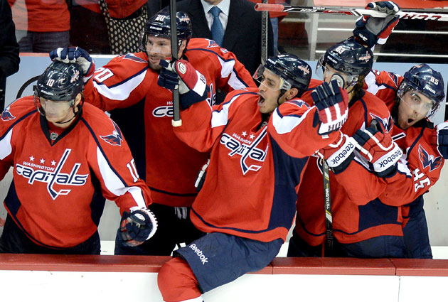 The Caps bench celebrates the final goal that sealed the division title. (Getty Images)