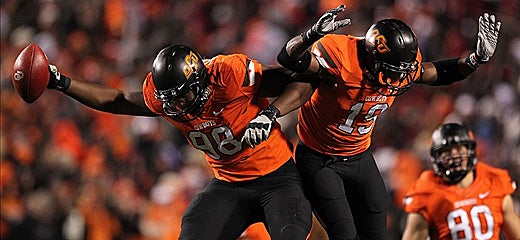 Davidell Collins (98) celebrates with cornerback Brodrick Brown (19) (US Presswire)