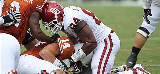 Sooners defensive end Frank Alexander (84) sacks Texas Longhorns quarterback David Ash (14) (US Presswire)