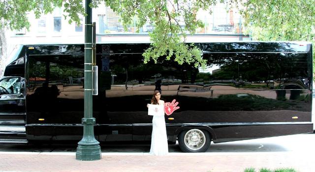 Stephanie Flores stands in front of the party bus Chandler Parsons supplied.