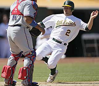 After a Coco Crisp double, Cliff Pennington slides in safely during the seventh to tie the game. (AP)