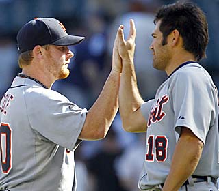     Phil Coke celebrates with Johnny Damon as Detroit wins to snap a string of 10 straight road series losses. (AP)