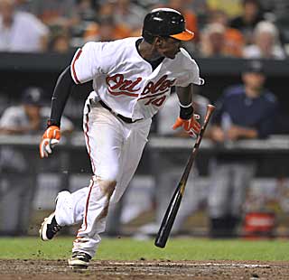 Adam Jones hustles down the line after dropping down a bunt in the bottom of the 11th. (AP)