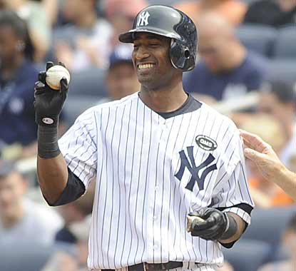 Eduardo Nunez holds the ball that was retrieved after he got his first major-league hit, an RBI single in the seventh inning. (AP)