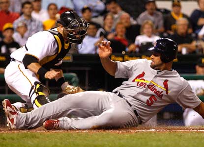 Albert Pujols makes it look easy as he slides past the Pirates in yet another dominant performance.  (AP)