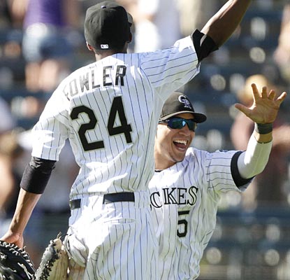 Dexter Fowler and Carlos Gonzalez are jumping for joy after the Rockies complete the nine-run comeback for the sweep.  (AP)