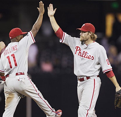 Jimmy Rollins and Jayson Werth celebrate after the Phillies have to work extras to put away the NL West-leading Padres.  (AP)