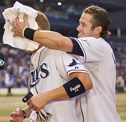 Evan Longoria gives Dan Johnson the ceremonial pie in the face after Johnson's walk-off blast.  (AP)