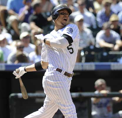 Carlos Gonzalez watches his first of two HRs fly out of Coors Field during a 10-5 win over the Dodgers. (AP)