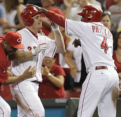 Jay Bruce, who delivers the walk-off hit, celebrates with Brandon Phillips, who represents the winning run in the 10th.  (AP)