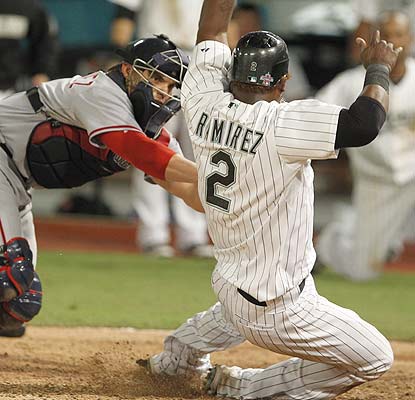 Safe! Hanley Ramirez slides home with the winning run on Chad Tracy's single in the 10th. (AP)