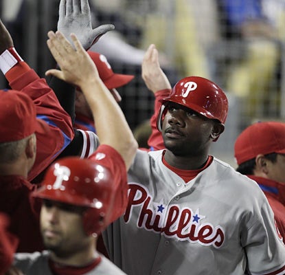 Slugger Ryan Howard provides one of two three-run home runs for the Phillies, who keep pace behind Atlanta in the NL East. (AP)
