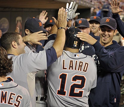 Gerald Laird is mobbed by his Tigers teammates in the dugout after his timely home run. (AP)