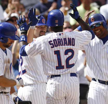 Alfonso Soriano is congratulated by Xavier Nady and Marlon Byrd after hitting a three-run HR against the Mets. (AP)