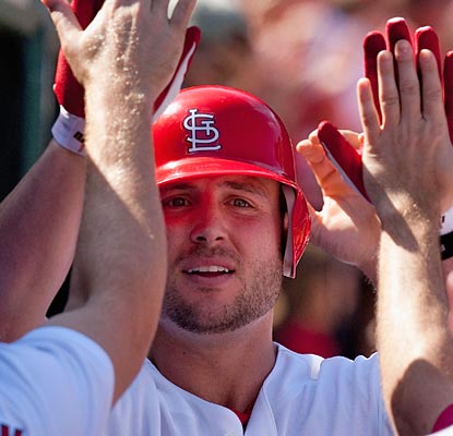 Matt Holliday meets the welcoming party in the dugout after he blasts his 25th homer of the season.  (Getty Images)