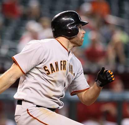 Nate Schierholtz hits a two-run triple off Aaron Heilman in the 11th to accelerate the Giants past the Diamondbacks.  (AP)