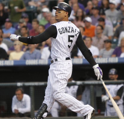 And the hits just keep on comin' for Carlos Gonzalez, who watches a HR fly out as the Rockies defeat the Reds.  (AP)