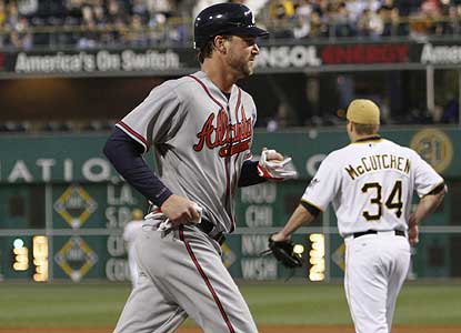 Despite giving up eight hits, Derek Lowe -- who scores a run here -- defeats Pittsburgh for the 10th straight time. (AP)