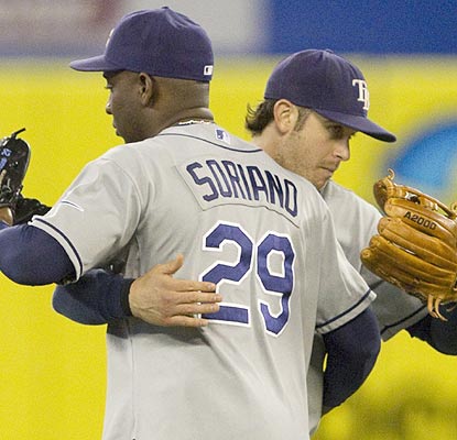 He's a team guy. Evan Longoria scores the go-ahead run and has a hug for Rafael Soriano after the win. (AP)