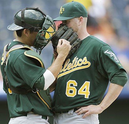 Kurt Suzuki gives Bobby Cramer some words of wisdom during his victorious big-league debut.  (AP)