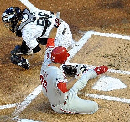 Marlins catcher Brad Davis is late with the tag as Chase Utley slides in to score. (US Presswire)