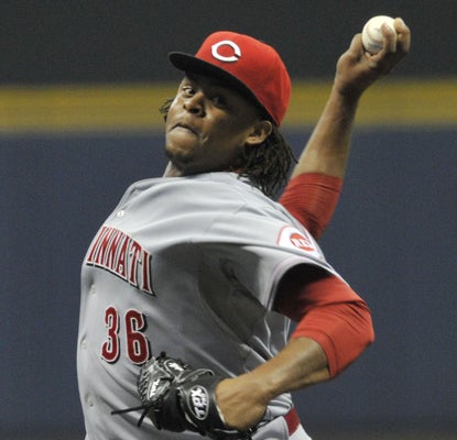 The Reds' Edinson Volquez allows just one run over eight innings to help his team hold off the Brewers.  (AP)