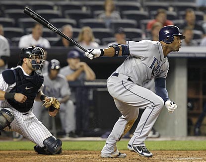 Carl Crawford, shown delivering an RBI single in the fifth inning, later adds a solo home run in the seventh.  (AP)