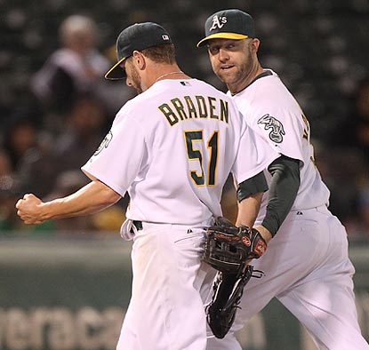 Kevin Kouzmanoff congratulates Dallas Braden on his fine fielding play to end the second inning.  (Getty Images)