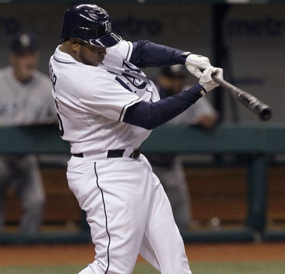 Willy Aybar lines a fifth-inning RBI single off the Mariners' Jason Vargas. (Getty Images)
