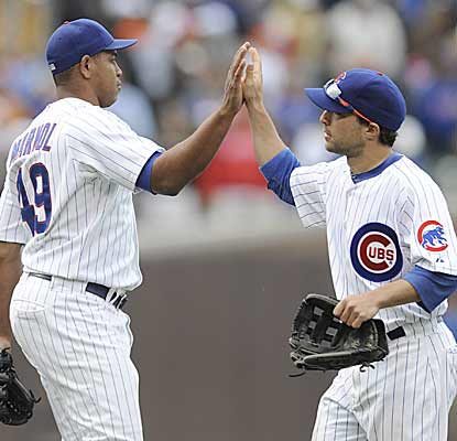Carlos Marmol and Sam Fuld (right), celebrate after defeating the Cardinals with Fuld's go-ahead single. (AP)