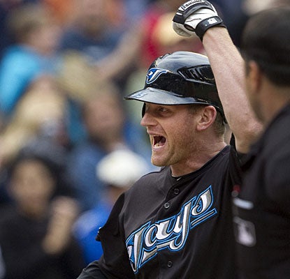Lyle Overbay enjoys his walk-off homer in the 11th inning, the fourth dinger of the game for Toronto. (AP)