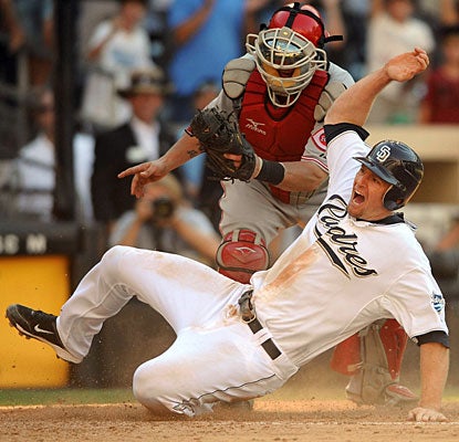 Chase Headley slides for the game-winning run on the hit by Chris Denorfia. (US Presswire)