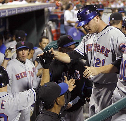 Rookie pinch-hitter Lucas Duda is greeted by teammates following his key three-run double in the seventh.  (AP)
