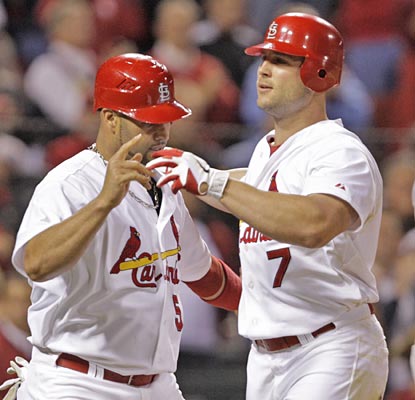 Matt Holliday is congratulated at the plate after his sixth-inning home run ties the game at 4.  (AP)