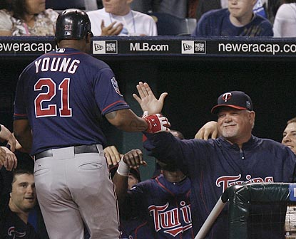 Delmon Young is congratulated by Twins manager Ron Gardenhire after hitting the go-ahead home run in the seventh inning.  (AP)