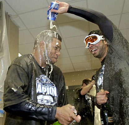Willy Aybar and Carlos Pena enjoy a little bubbly after the Rays wrap up the AL East.  (AP)