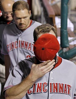 Jay Bruce tries to hide after his mistake proves too costly for the Reds to overcome. (AP)