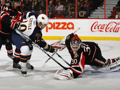 Bryan Little stuffs a rebound past a sprawling Brian Elliott for his first of two goals in the game.  (Getty Images)