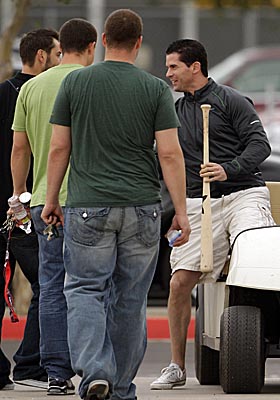 Michael Young greets teammates after arriving for the first day of Rangers spring training. (AP)