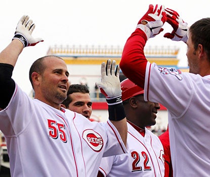 Cincinnati's Ramon Hernandez (55) high-fives Chris Heisey after hitting a walk-off homer. (AP)