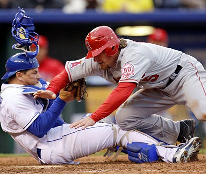 Jeff Mathis is tagged out by Royals catcher Matt Treanor as he tries to score in the eighth. (AP)