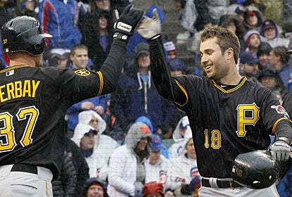 Lyle Overbay welcomes Neil Walker home after Walker takes it out of the park for a grand slam. (AP)