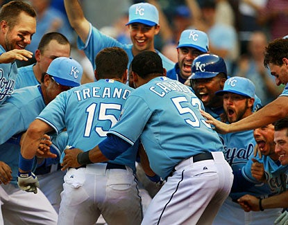 Kansas City's Matt Treanor is greeted at home after hitting a walk-off home run in the 13th inning. (AP)