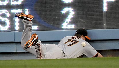 Aubrey Huff's difficulties playing right field -- like here on Marcus Thames' triple in the seventh inning -- help L.A. win.  (AP)