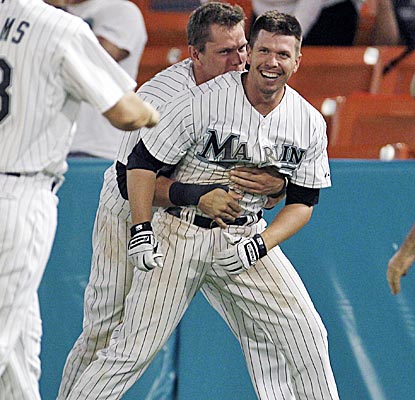 Logan Morrison bear-hugs Donnie Murphy after Murphy drives in the winning run in the 10th inning to beat the Nats.  (AP)