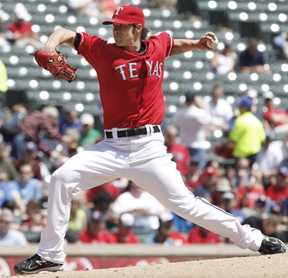 C.J. Wilson gets the win on the mound for the Rangers, allowing two earned runs and six hits in seven innings. (AP)